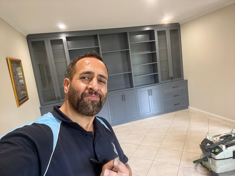 Alex Nemati taking selfie in showroom with custom cabinetry