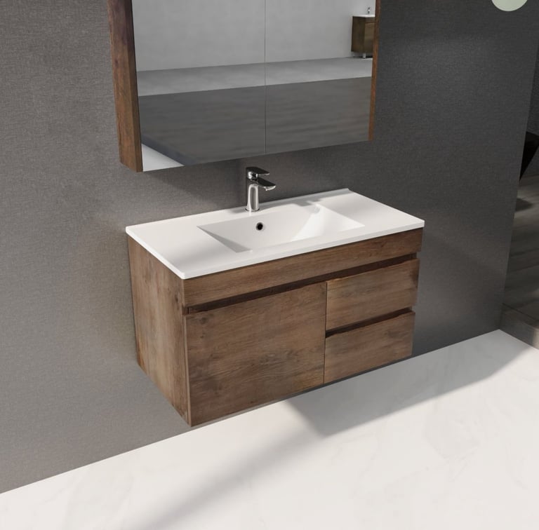 Modern bathroom vanity with white ceramic sink and wood-grain cabinet, chrome faucet, and mirror mounted on gray tile wall